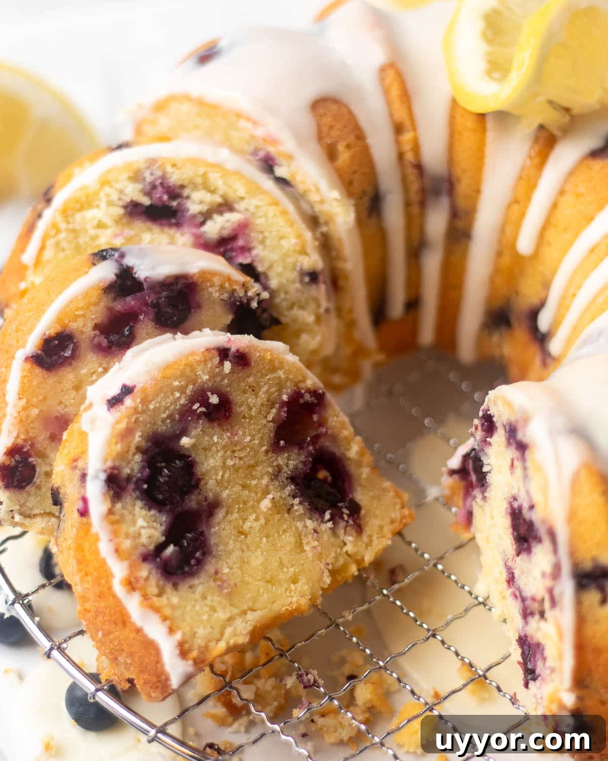 Blueberry Lemon Pound Cake Recipe with Zesty Glaze 7 Step-by-step guide to making a blueberry and lemon pound cake, featuring a moist cake with lemon glaze and blueberry accents, garnished with lemon slices.