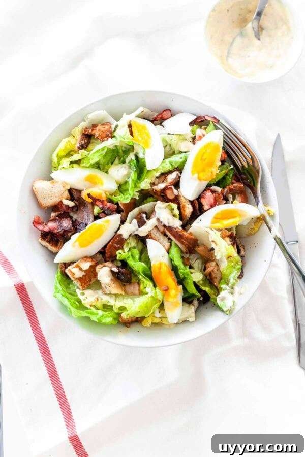 Classic Chicken Caesar Salad Recipe with Crispy Croutons 4 Classic chicken caesar salad in a white bowl.