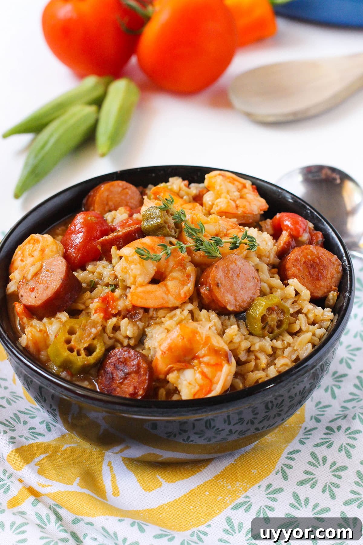 Bowl of Easy One Pot Creole Gumbo With Sausage and Shrimp Over Rice in Black Bowl.