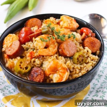 Bowl of Easy One Pot Creole Gumbo With Sausage, Shrimp, Okra Over Rice in Black Bowl.