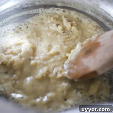 Butter and flour being cooked in large pot.