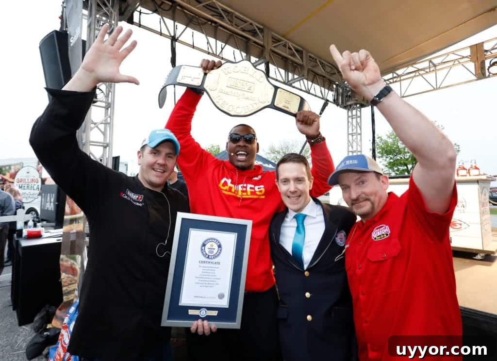 Guinness World Record: Largest Grilling Lesson Experience 2 Four men with their arms up holding their winning certificates and a large belt.