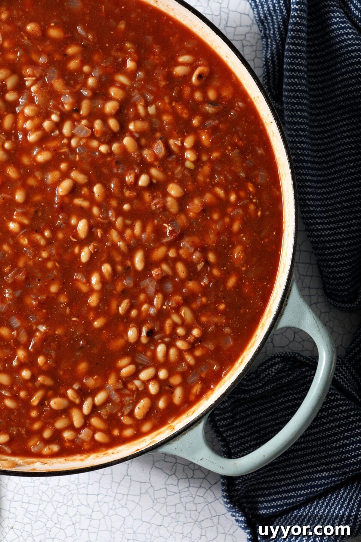 Close up of beans and sauce in a pan before baking