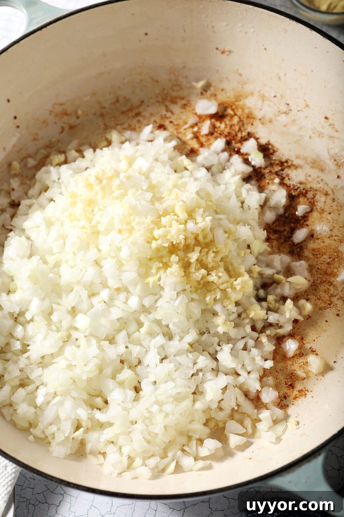 Onions and garlic in a pan with bacon fat