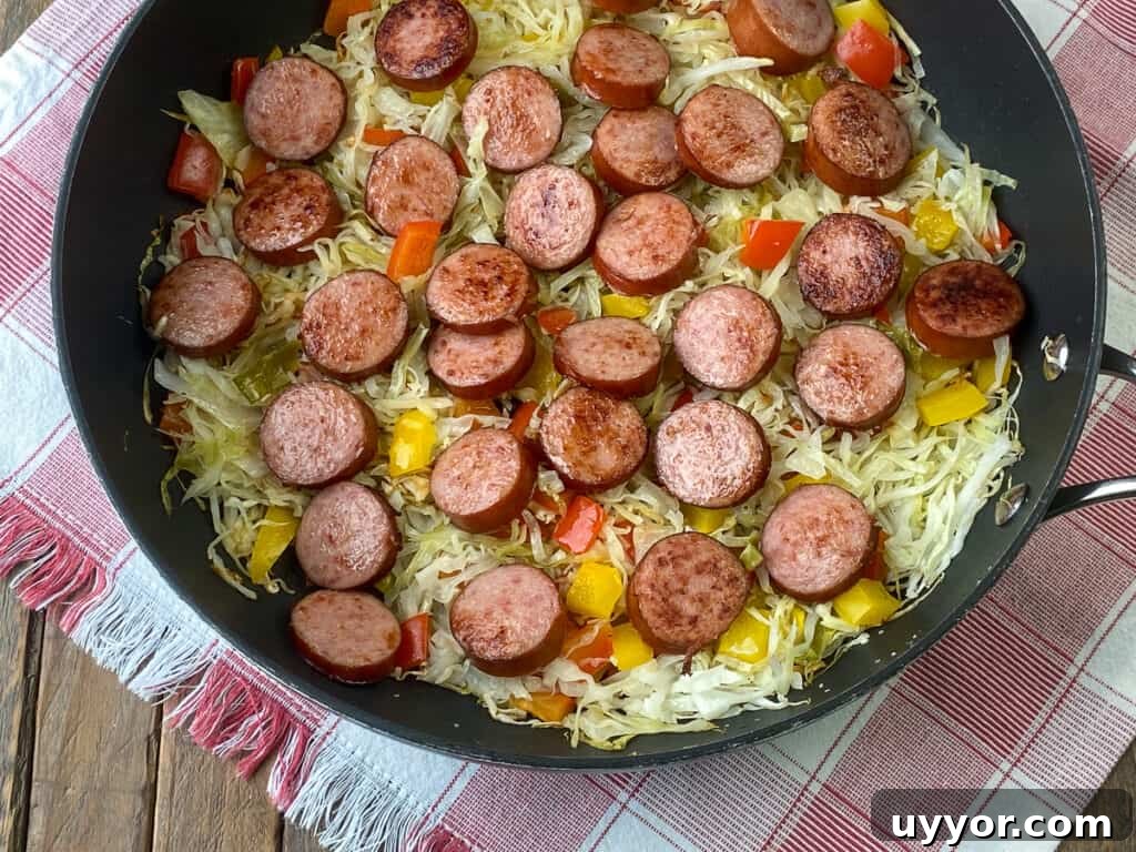 Savory Kielbasa and Cabbage Skillet Recipe for Weeknight Dinners 3 Skillet of Kielbasa coins on a bed of cabbage