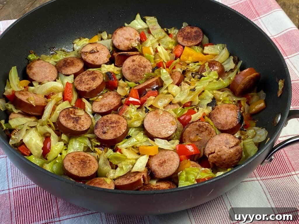Savory Kielbasa and Cabbage Skillet Recipe for Weeknight Dinners 6 Side view of slices of smoked sausages cooked with cabbage in a skillet