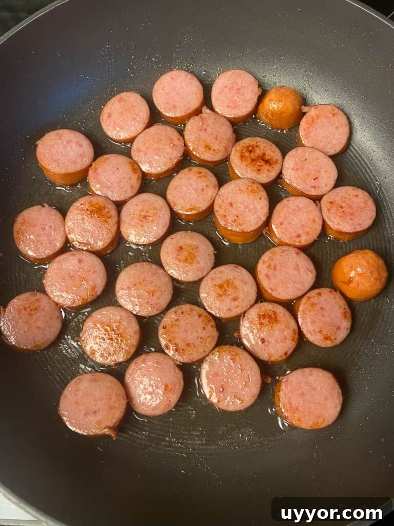 Savory Kielbasa and Cabbage Skillet Recipe for Weeknight Dinners 7 Kielbasa browning in vegetable oil
