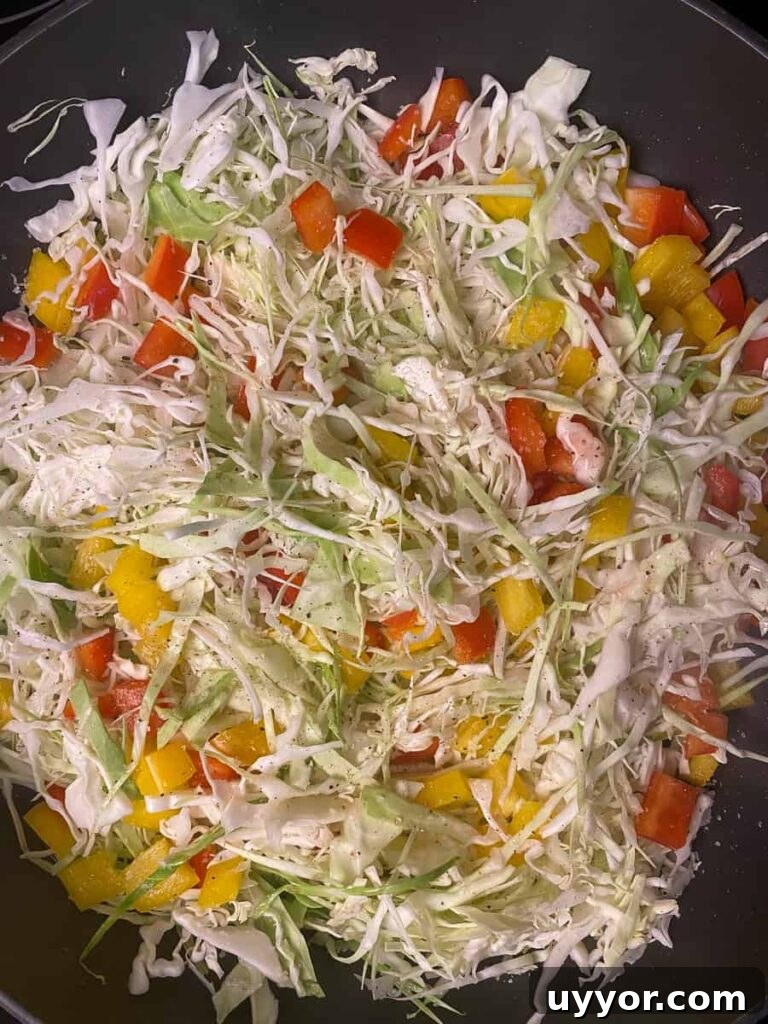 Savory Kielbasa and Cabbage Skillet Recipe for Weeknight Dinners 9 Raw shredded cabbage with chopped bell pepper