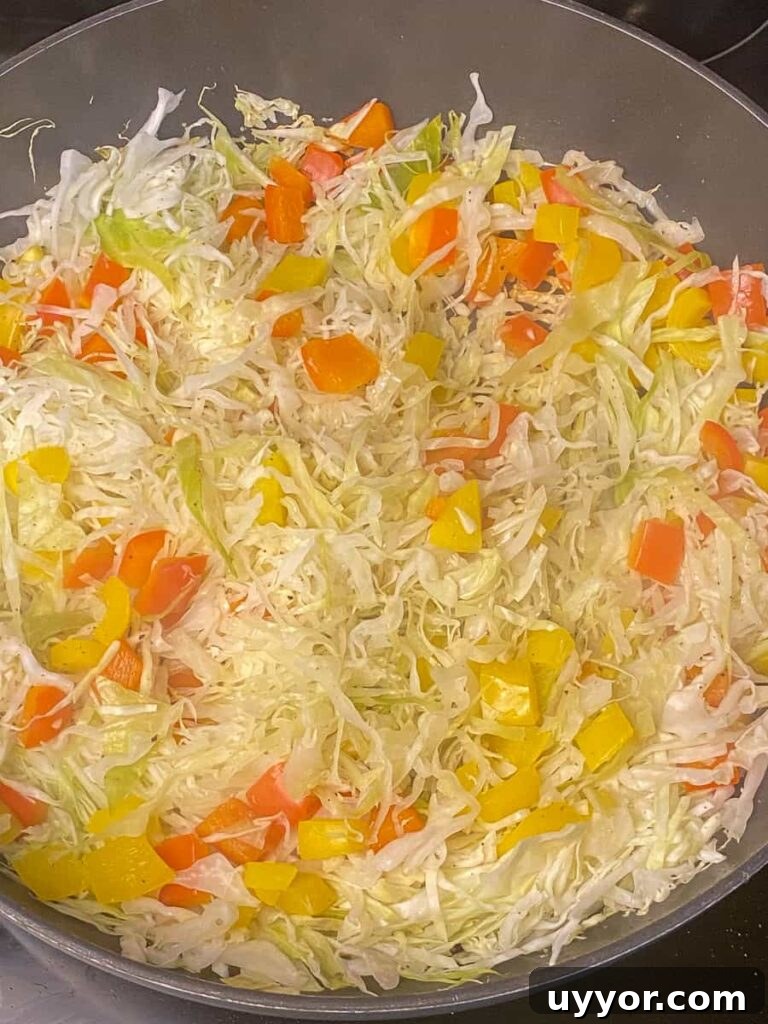 Savory Kielbasa and Cabbage Skillet Recipe for Weeknight Dinners 10 Sliced cabbage beginning to wilt while cooking