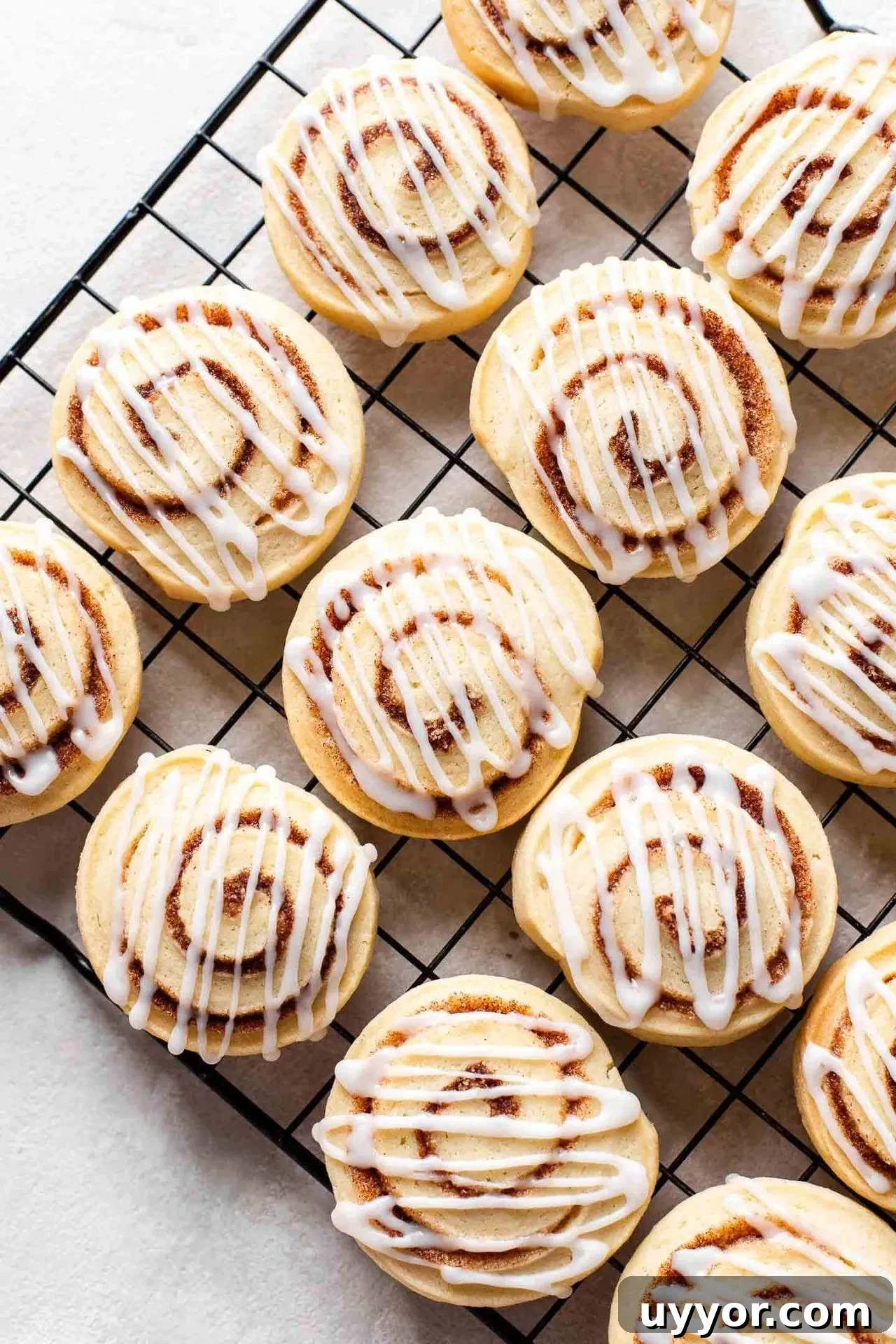 Cinnamon Roll Cookie Recipe: Soft Swirls with Cream Cheese Glaze 11 iced cinnamon roll cookies on wire rack