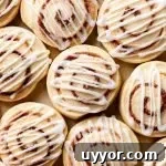 iced cinnamon roll cookies on parchment lined board