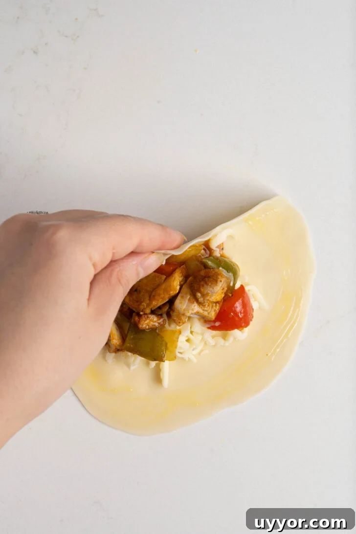 Cheesy Chicken Empanadas with Homemade Savory Filling 6 Chicken empanadas being closed.