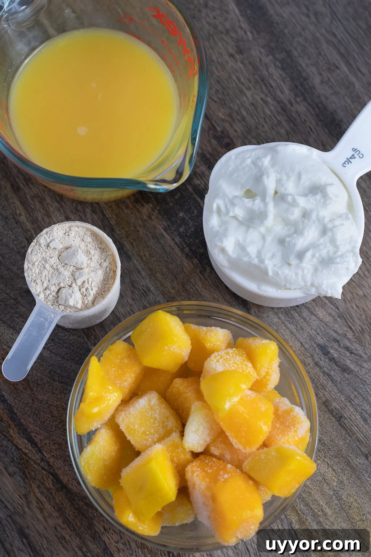 Orange juice, greek yogurt, protein powder and frozen mango chunks