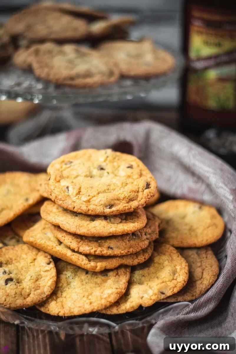 Rum-Infused Chocolate Chip Cookies: Chewy & Boozy Recipe 2 Delicious rum chocolate chip cookies placed on a glass plate.