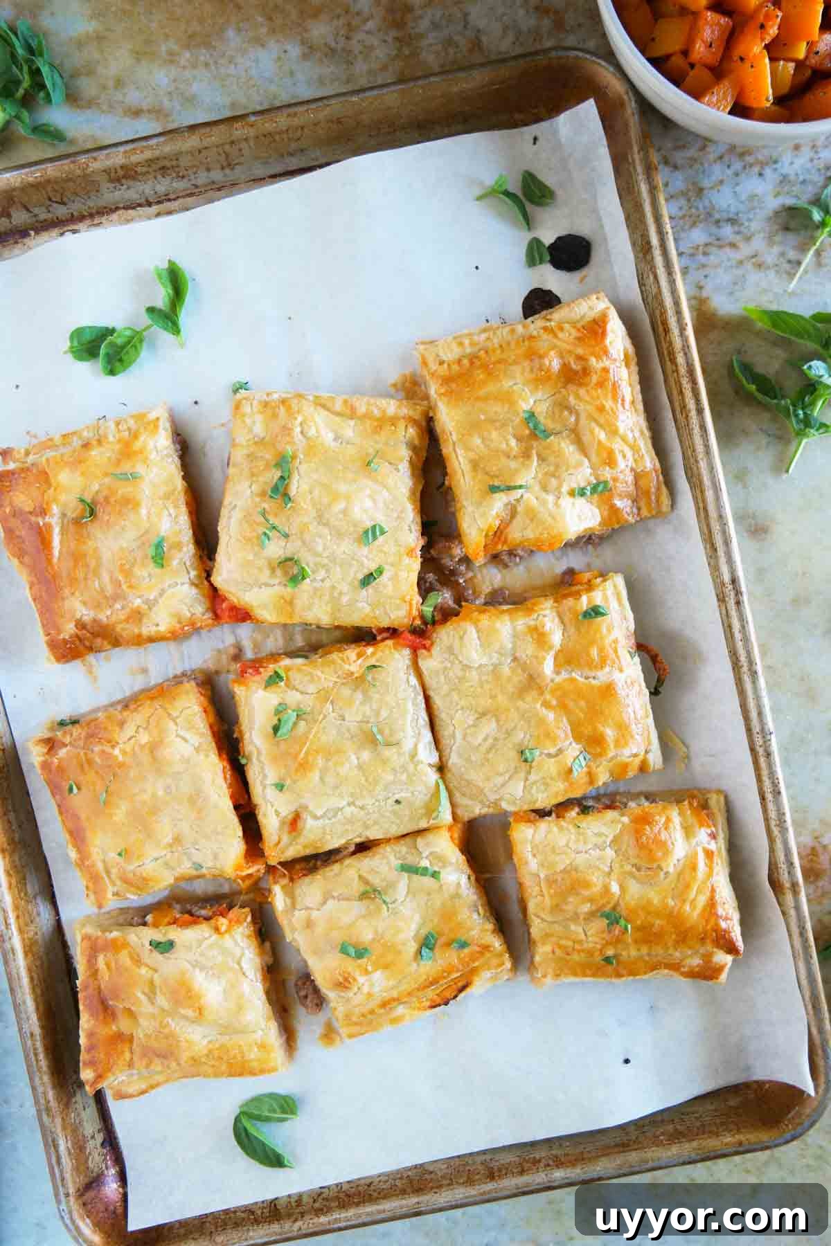 Savory Sausage and Butternut Squash Slab Pie Recipe 2 Sausage and Butternut Squash Slab Pie sliced into squares on a baking sheet.