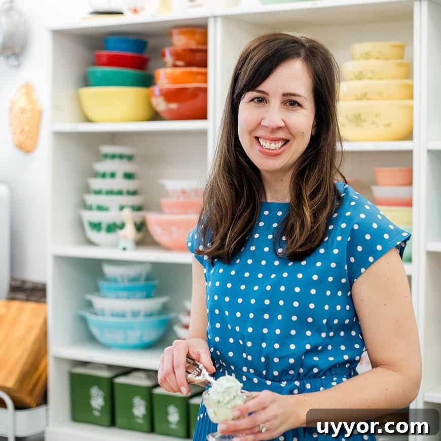 Strawberry Pretzel Salad Recipe with Creamy Cheesecake Layer 3 woman scooping pistachio salad into a parfait dish, with colorful vintage bowls in the background.