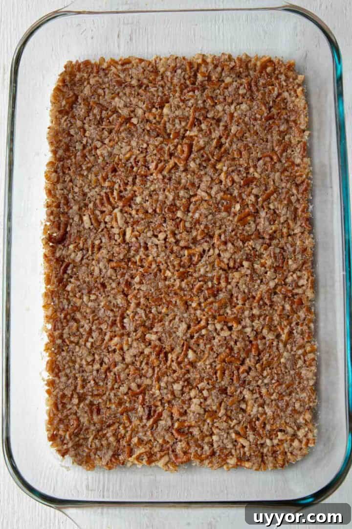 Strawberry Pretzel Salad Recipe with Creamy Cheesecake Layer 6 cooked pretzel crust in a baking dish.