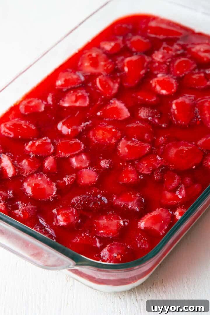 Strawberry Pretzel Salad Recipe with Creamy Cheesecake Layer 10 strawberry gelatin on top of a layered dessert.