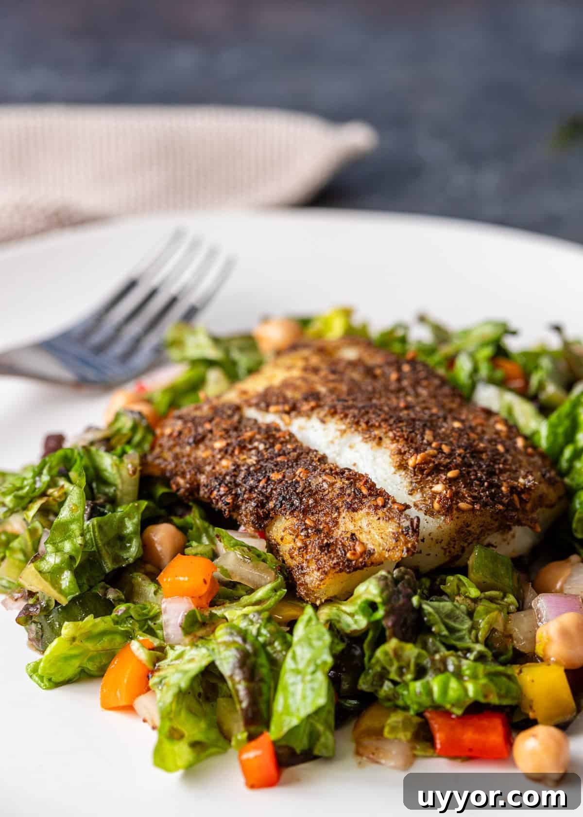 closeup: my cod recipe after pan frying over a green salad
