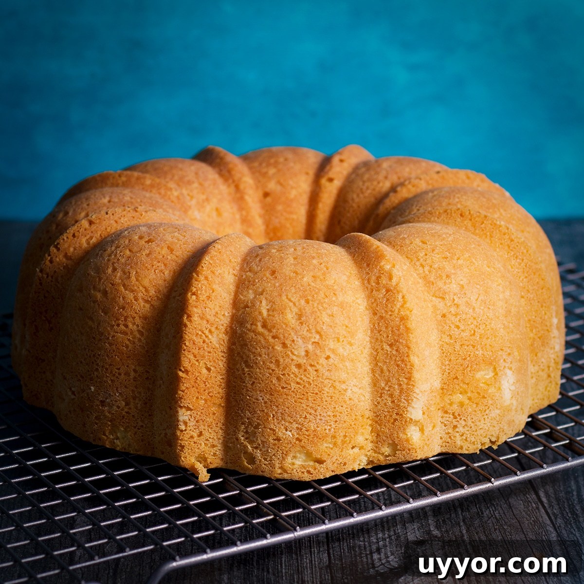 Lemon Bundt Cake with Zesty Tart Lemon Glaze 13 A freshly baked lemon bundt cake on a wire baking rack.