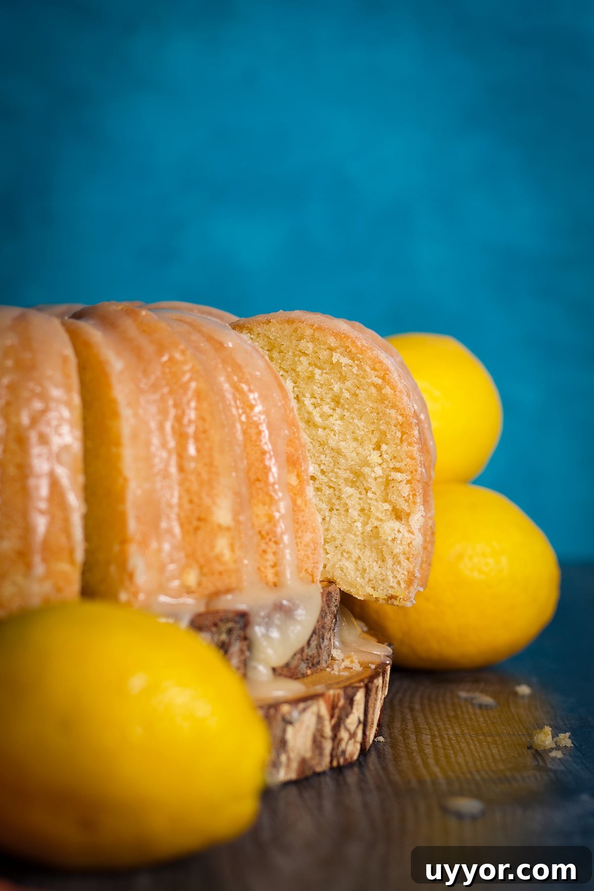 Lemon Bundt Cake with Zesty Tart Lemon Glaze 17 One slice of a lemon bundt cake set slightly askew from the rest of the cake.