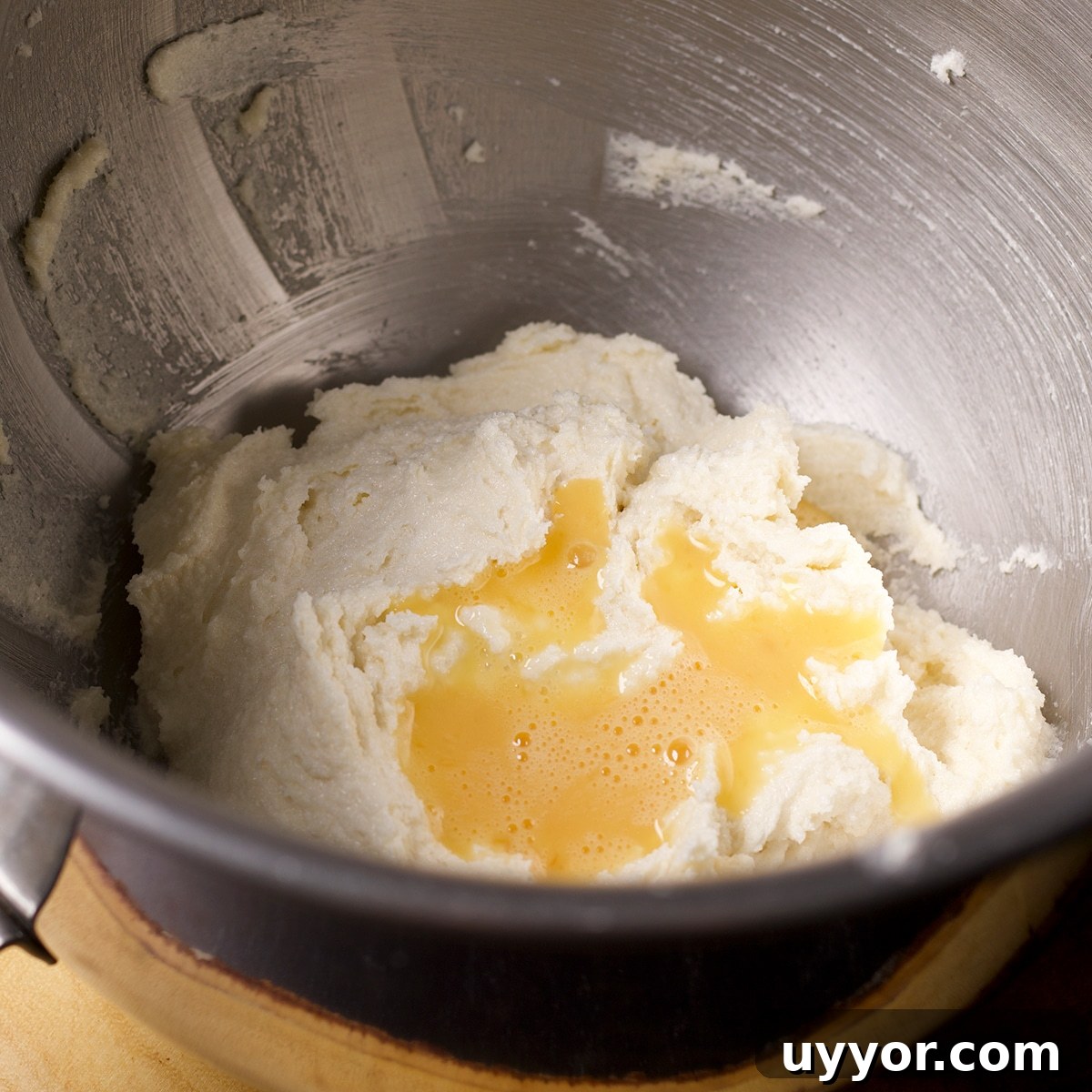 Lemon Bundt Cake with Zesty Tart Lemon Glaze 8 Beaten eggs that have been poured into a bowl containing butter and sugar.