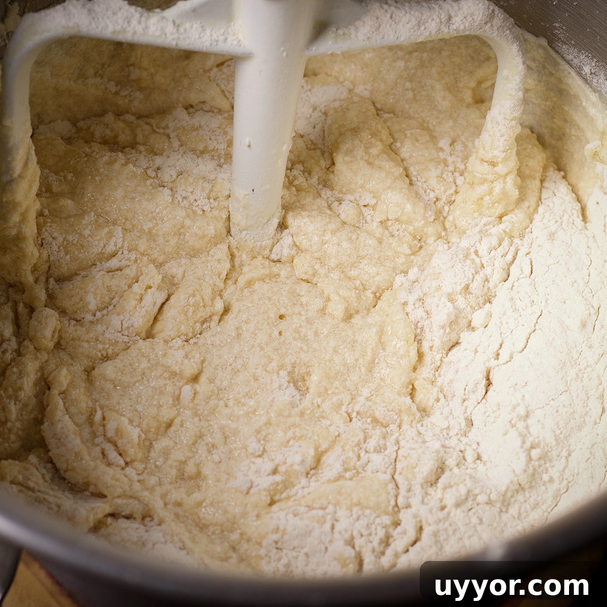 Lemon Bundt Cake with Zesty Tart Lemon Glaze 9 Adding flour and milk to a stand mixing bowl that's been fitted with the paddle attachment.