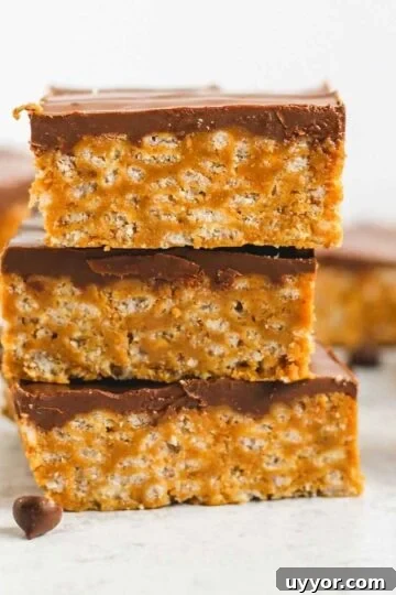 Healthier scotcheroo bars stacked 3 high.