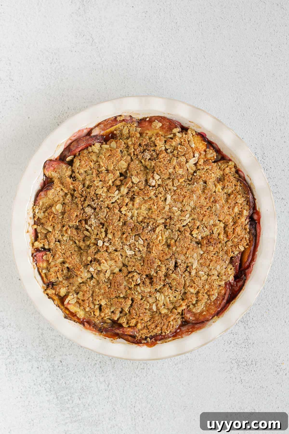 Whole-Grain Peach Crisp with Low Sugar Recipe 9 Baked peach crisp in a ceramic pie dish.