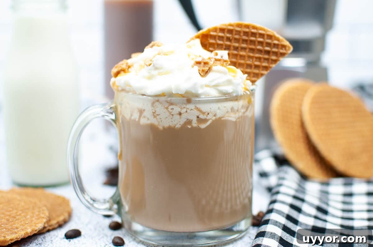 Copycat Crème Brûlée Latte Recipe Like Starbucks 5 Several stroopwaffles are placed next to a full glass mug of creme brûlée latte.