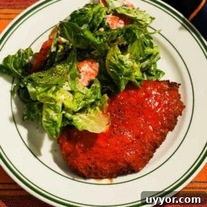 Crispy Panko Buffalo Chicken Cutlets With Tangy Sauce 8 Crispy buffalo chicken cutlet served with romaine and tomato salad.