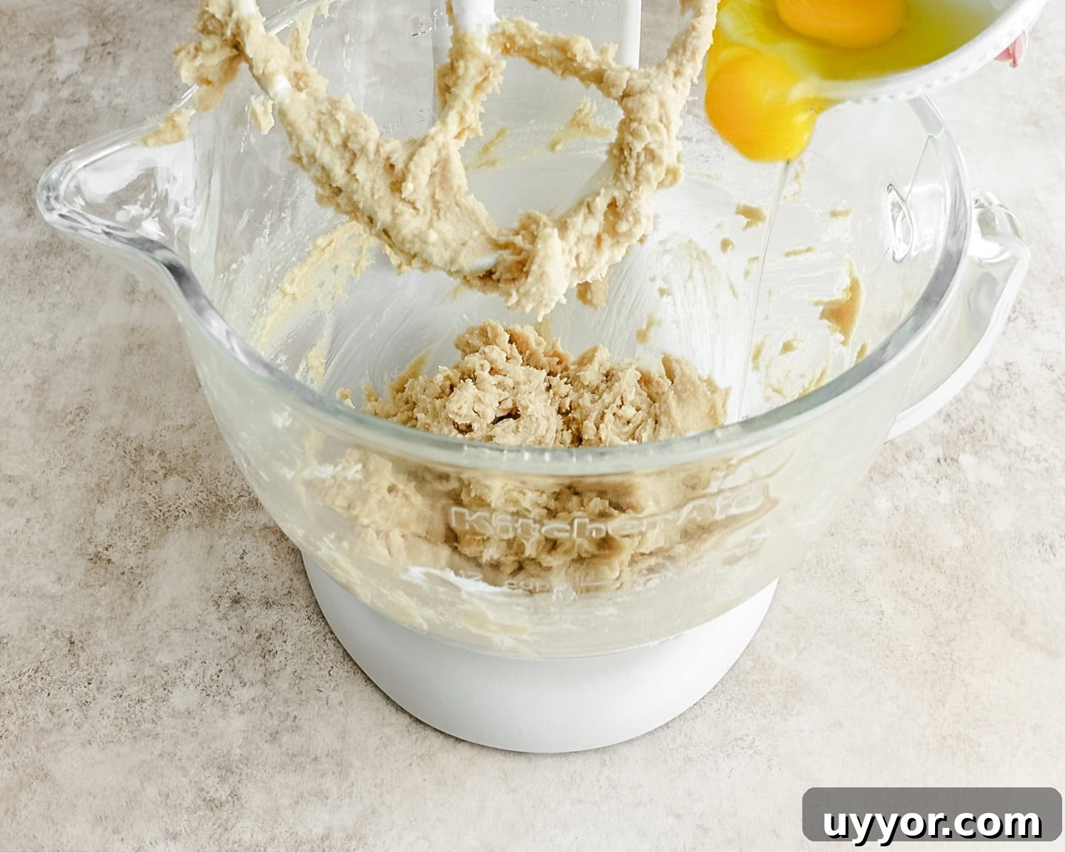 Add egg and egg yolk to the creamed mixture.