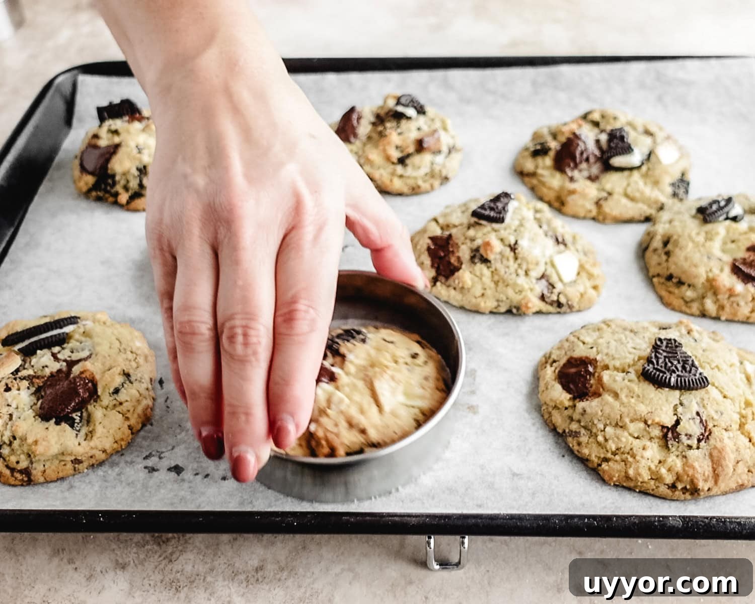 Use a round cookie cutter to circle around hot cookies to smooth edges.