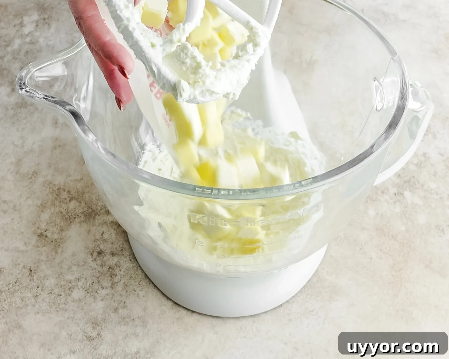Add cold cubed butter to the cream cheese.