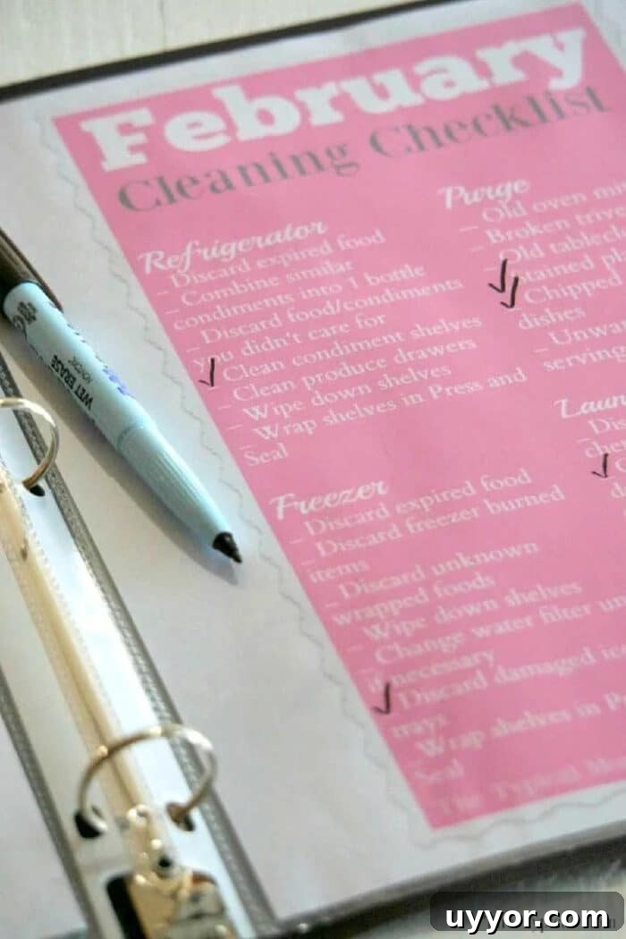 Home organization binder is genius and so easy to do! All the organization printables are here to download for free too! #organization #organize #homeorganization #printables #printable #cleaning A February cleaning checklist is neatly displayed in a home organization binder, with a pen resting on the open page, ready for your next task.