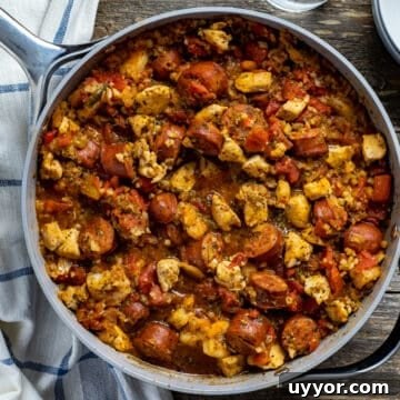 cooked jambalaya in pan on wooden table
