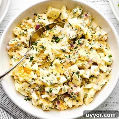 A white bowl of egg salad.