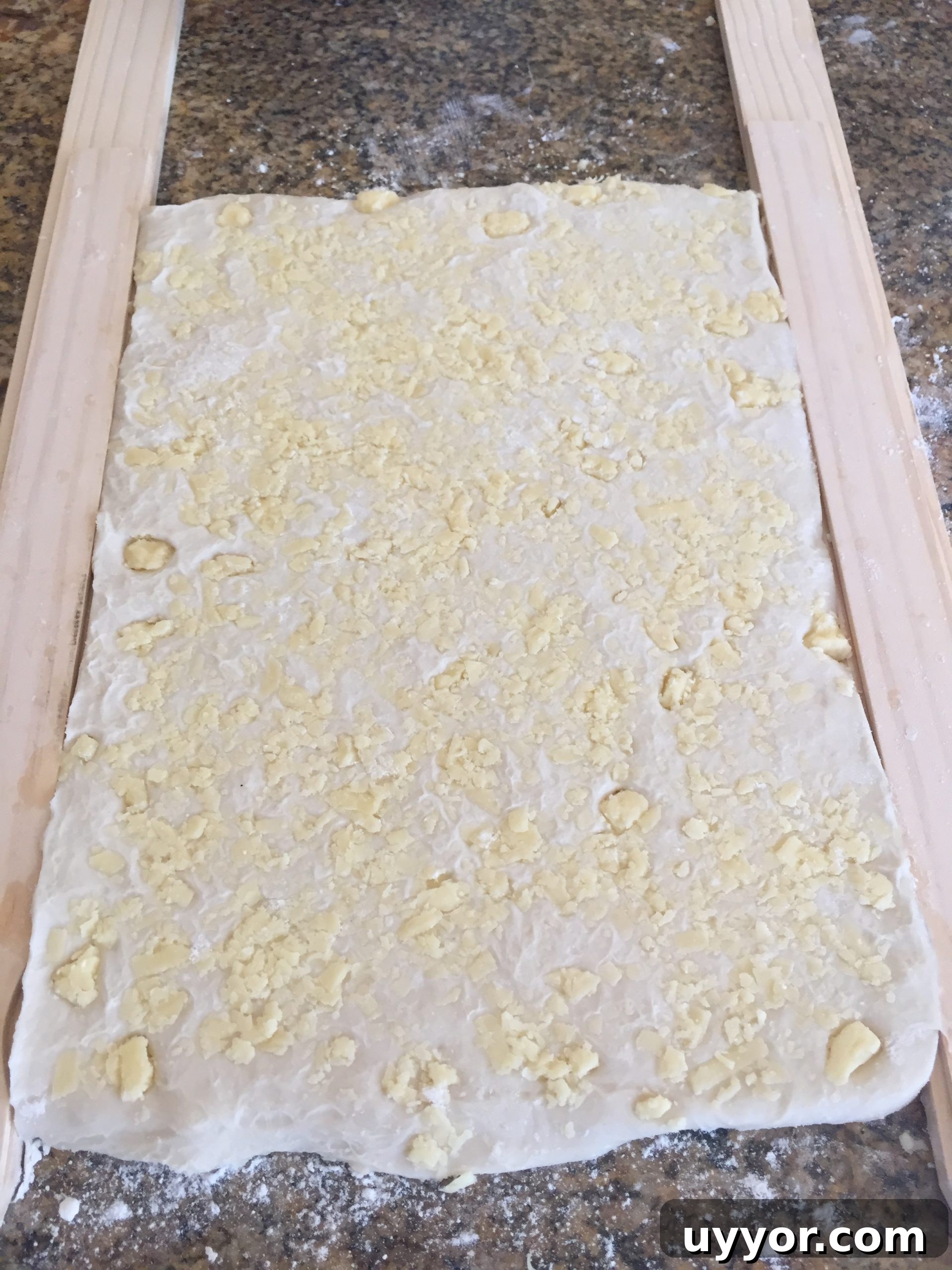 Roll dough until it reaches the height of the paint stick.