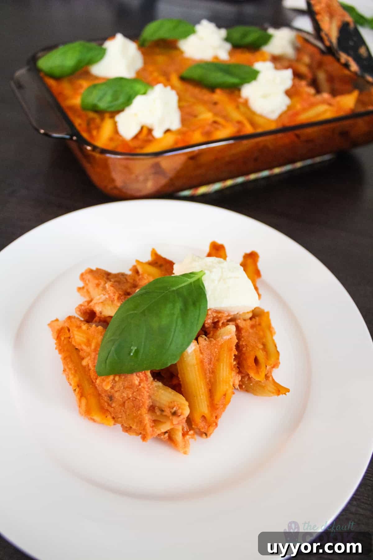 Cheesecake Factory Four-Cheese Pasta Copycat Recipe 2 Plate of four-cheese pasta with the casserole dish behind it.