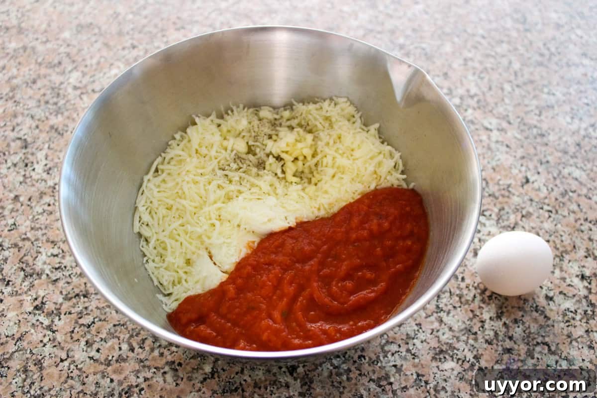 Cheesecake Factory Four-Cheese Pasta Copycat Recipe 4 All sauce components execpt the egg in a mixing bowl