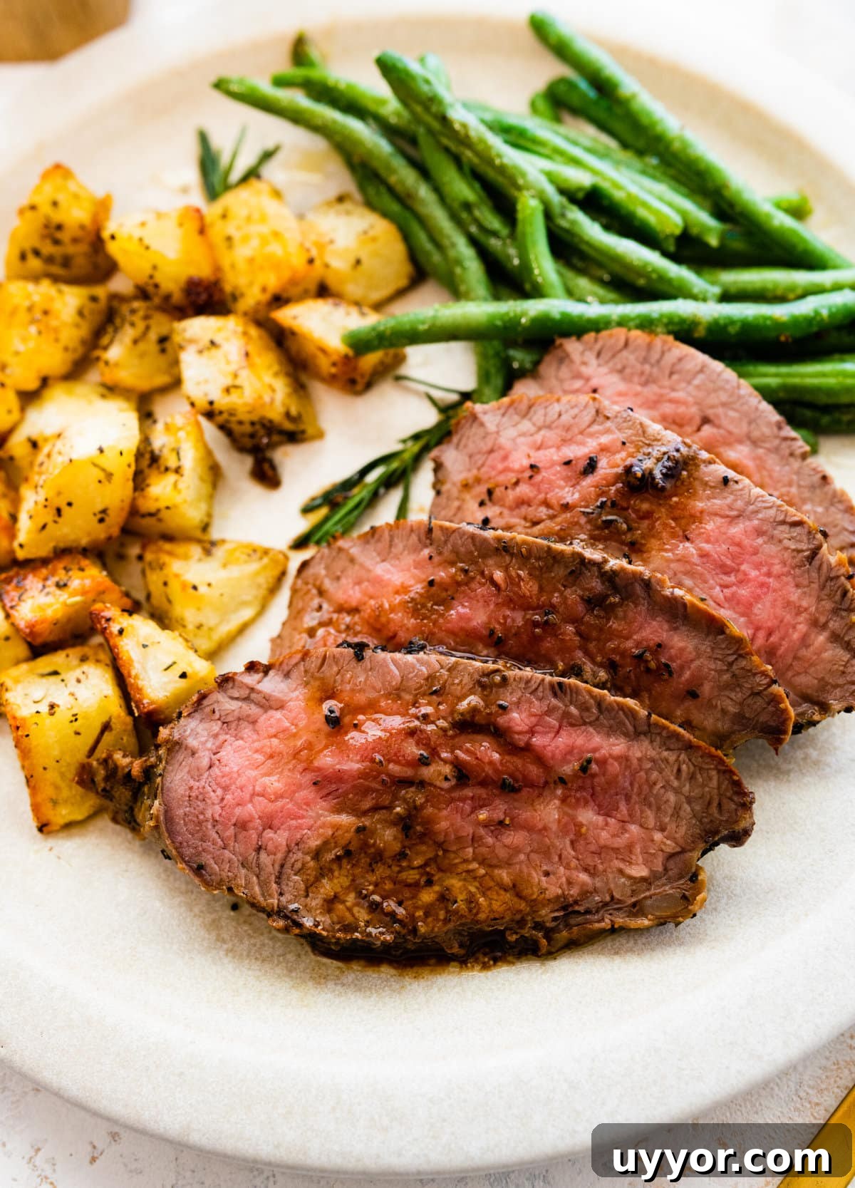 Serve the skillet tri-tip steak with potatoes and green beans.