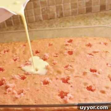 Strawberry Banana Pudding Cake Recipe — Moist Layer Cake 13 pouring banana pudding mix over a strawberry cake.