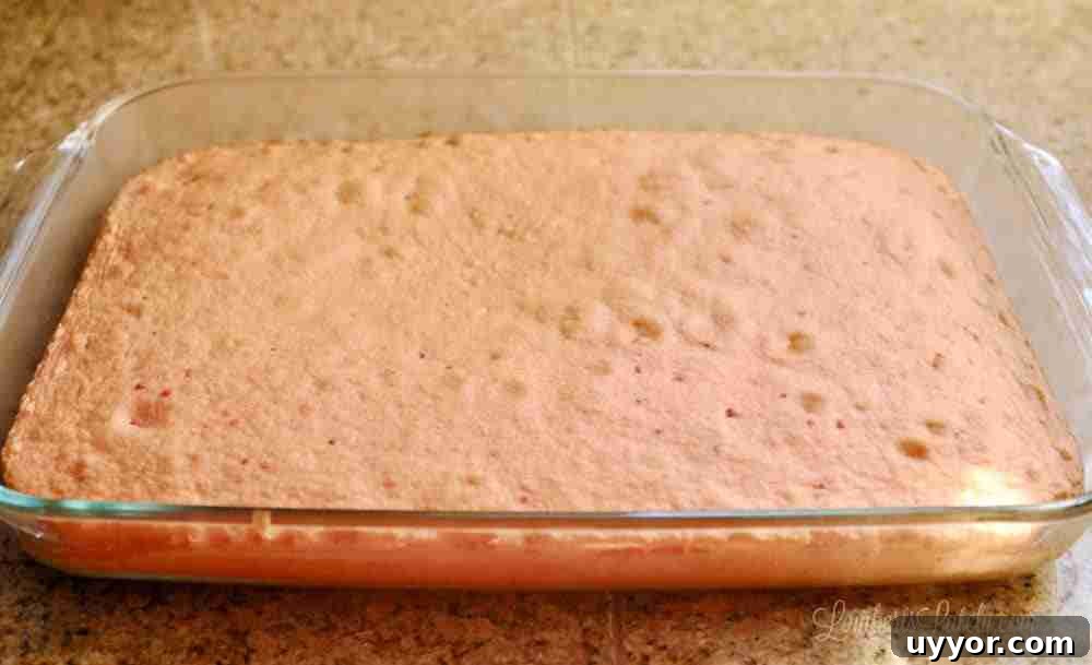 Strawberry Banana Pudding Cake Recipe — Moist Layer Cake 3 strawberry cake in a baking dish.