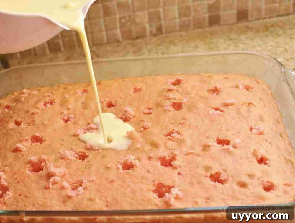 Strawberry Banana Pudding Cake Recipe — Moist Layer Cake 6 pouring pudding mix over a strawberry cake with holes.