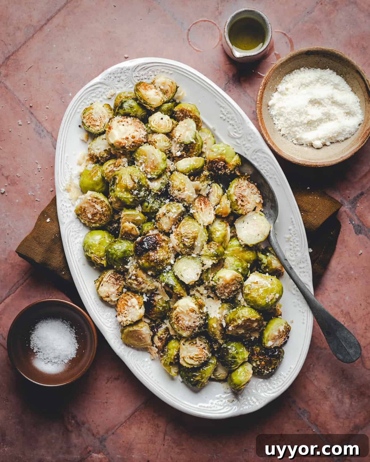 Garlic Parmesan Brussels Sprouts served on a white oval platter and photographed from the top.