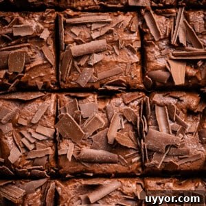 overhead close up chocolate banana cake covered with chocolate shavings, sliced