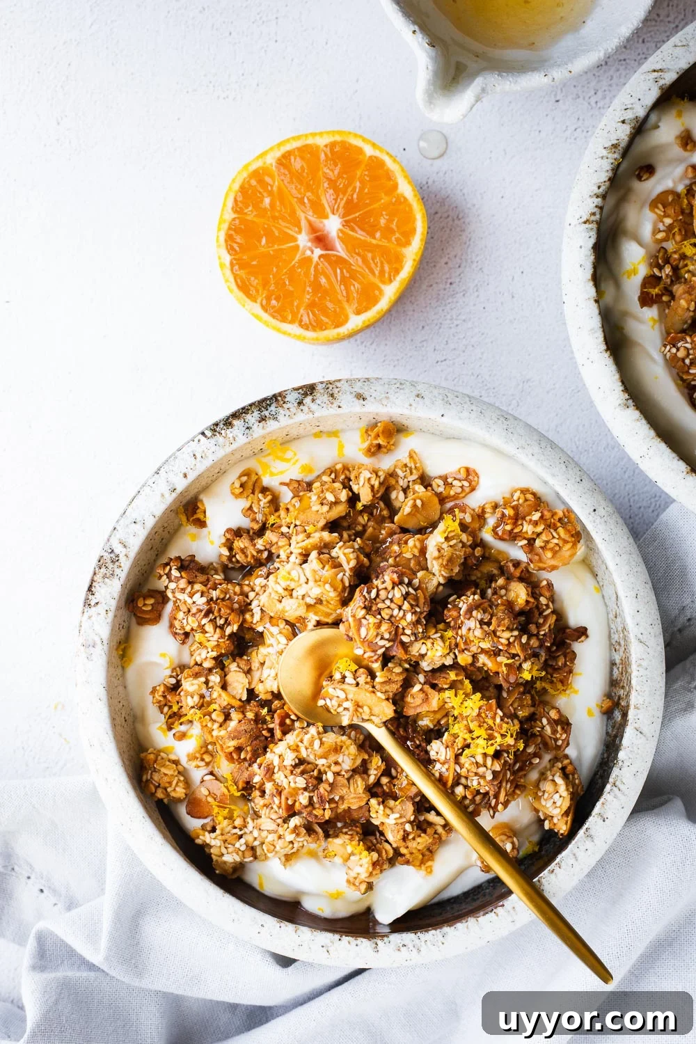 Tahini Sesame Granola with Honey & Orange 9 Tahini granola bowls with with yoghurt, orange and honey viewed from top down.