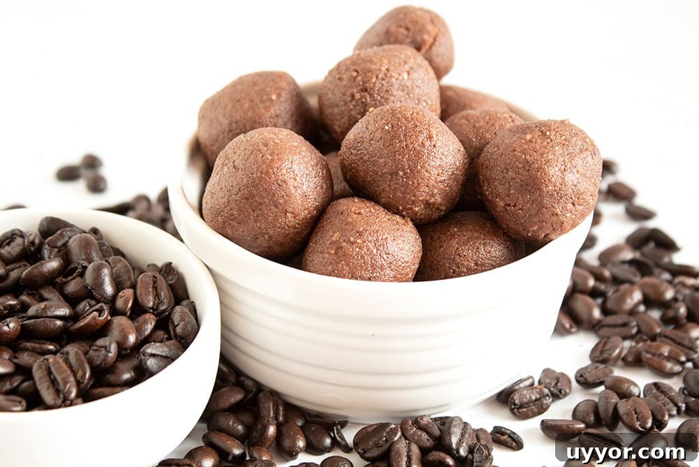 Keto Chocolate Coffee Fat Bombs — Caffeinated Low‑Carb Treats 2 keto chocolate coffee fat bombs in a white dish next to dish of coffee beans