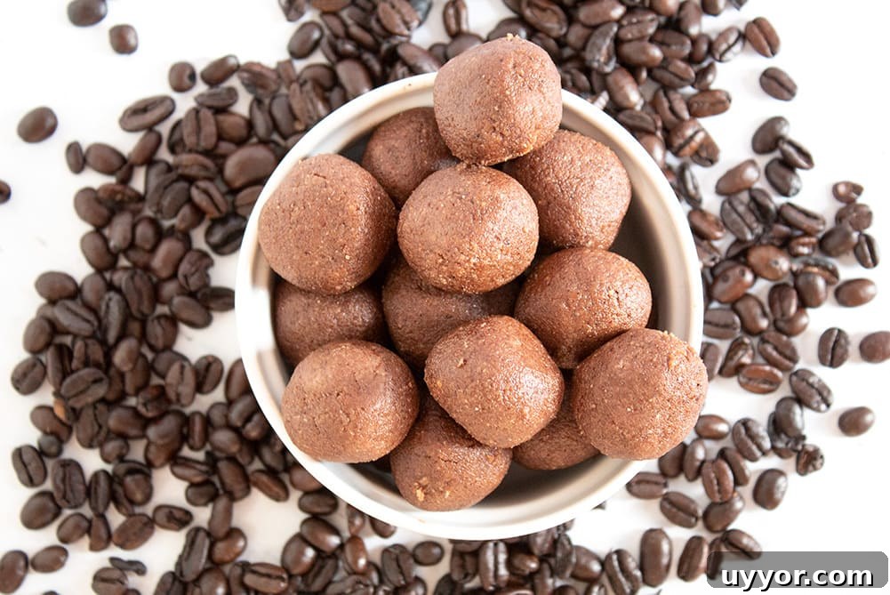Keto Chocolate Coffee Fat Bombs — Caffeinated Low‑Carb Treats 6 keto chocolate coffee fat bombs in a white bowl with coffee ground scattered about