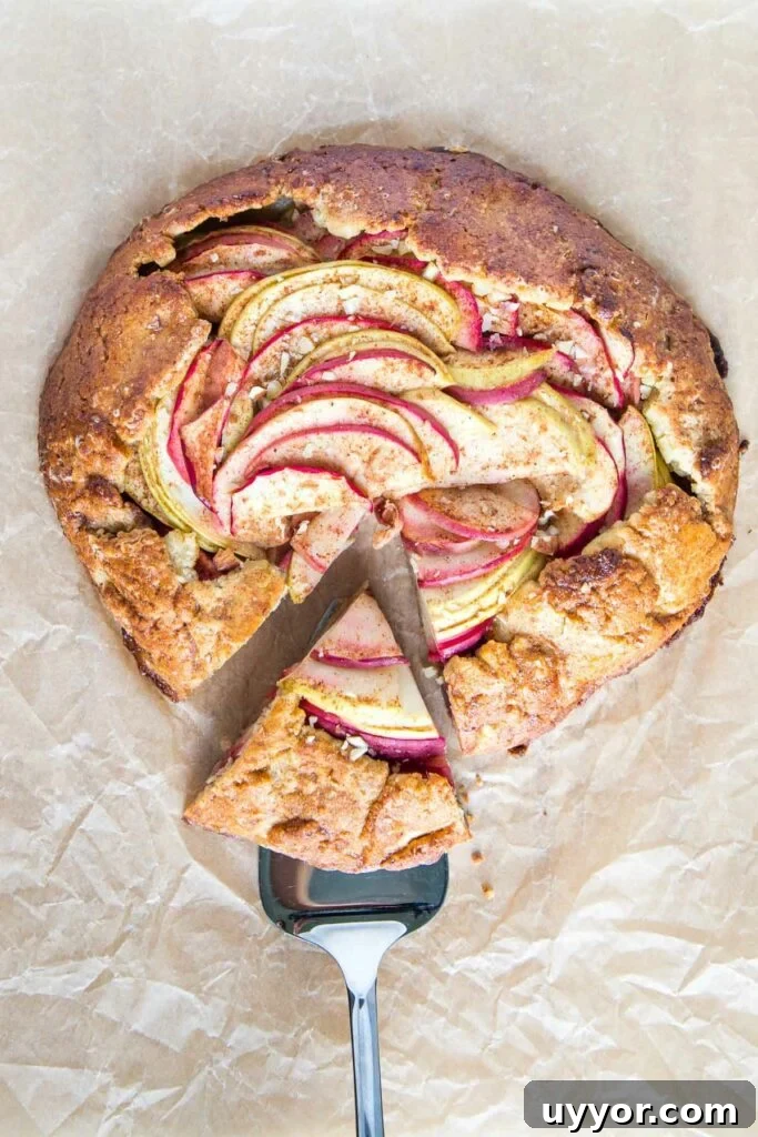 Apple galette with a slice on a serving piece.